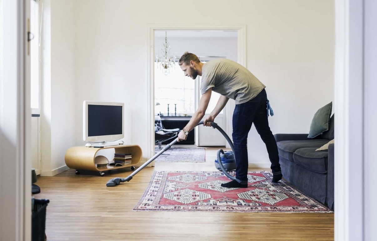 Person vacuuming with rounded lower back
