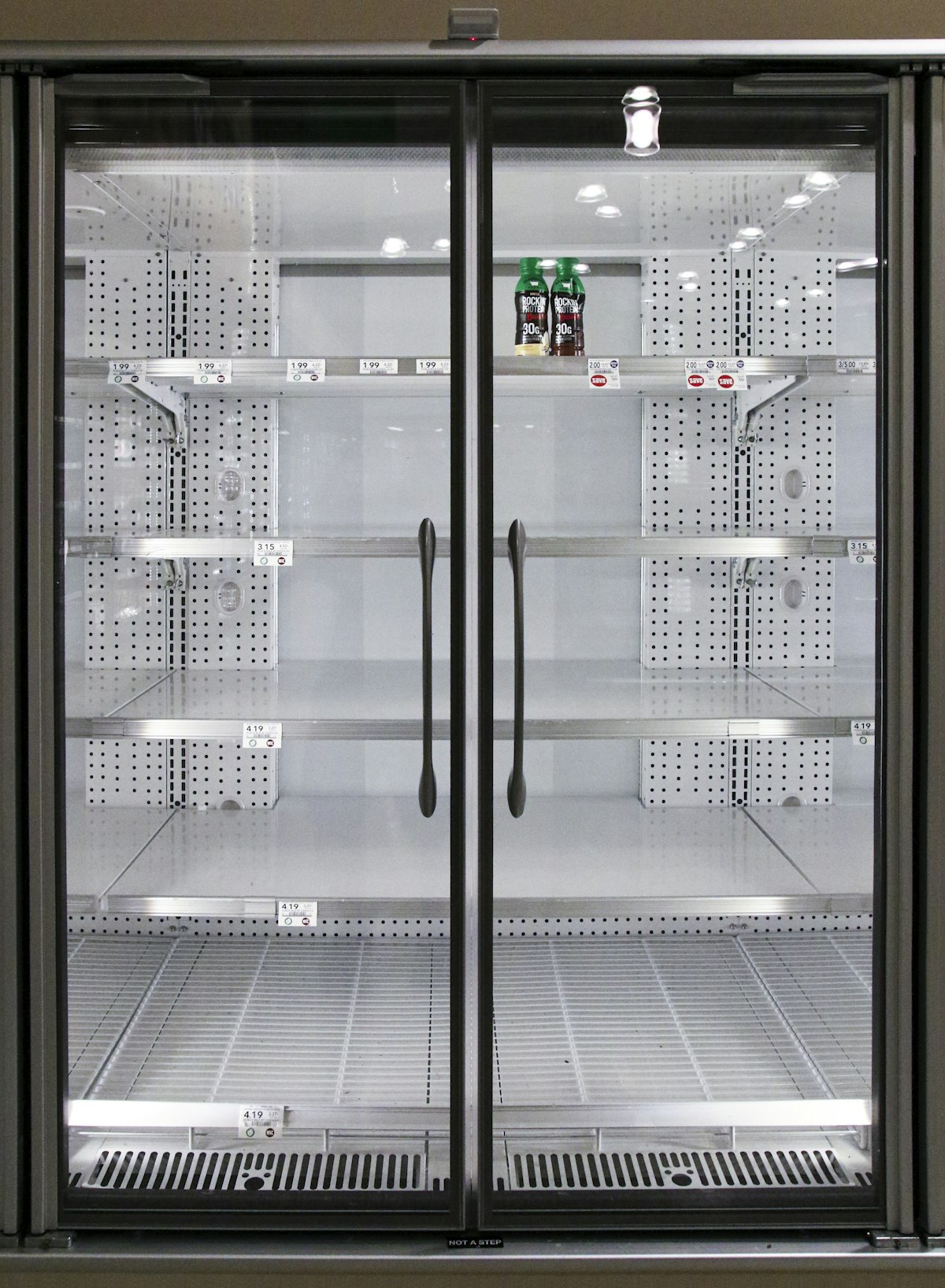 Person standing in front of an open fridge at night